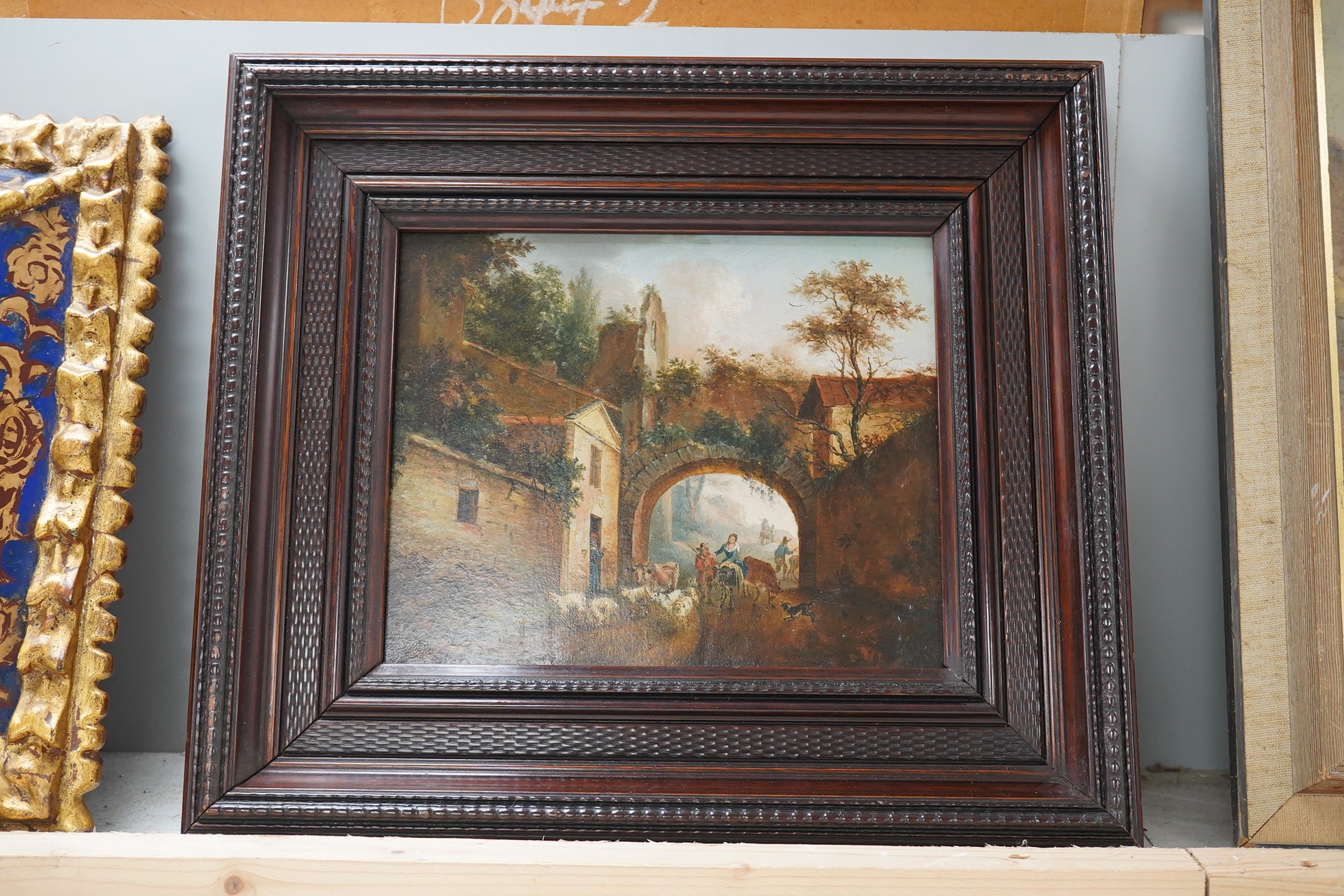 18th/19th century, Continental school, oil on panel, Street scene with figures herding animals, unsigned, 18 x 22cm, housed in a carved wood frame. Condition - good